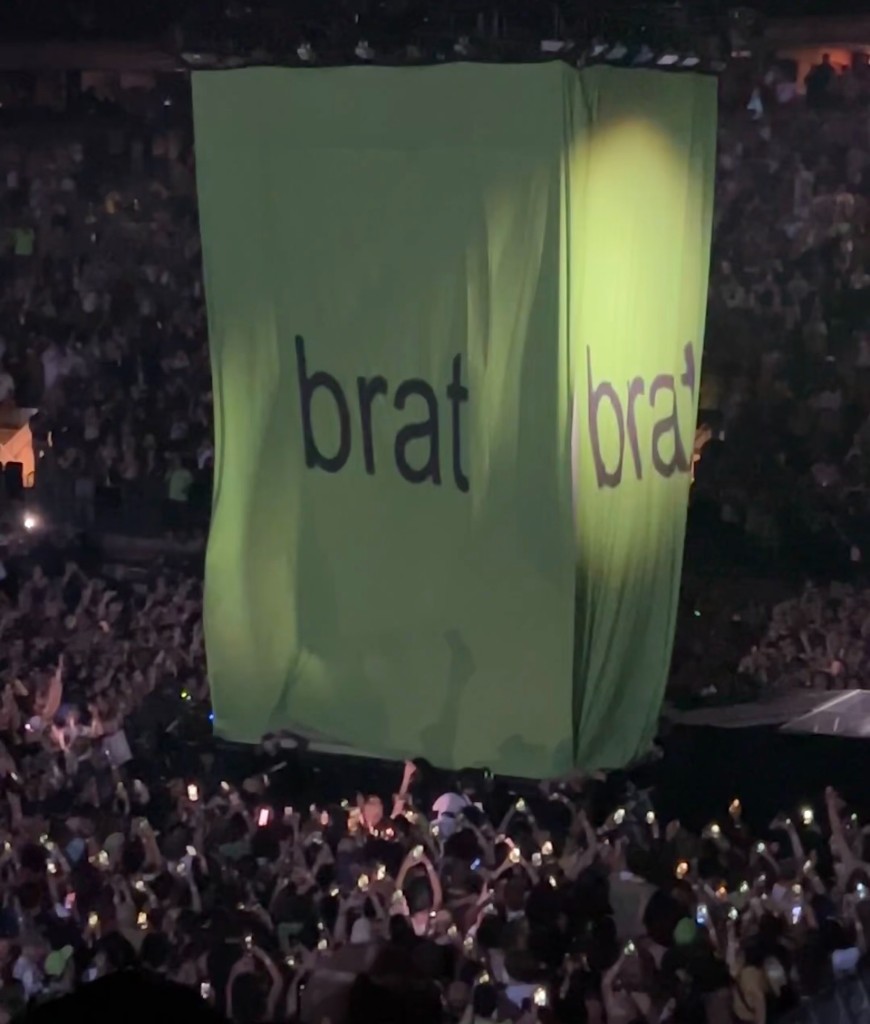 Reality: a brat concert cube over a crowd
